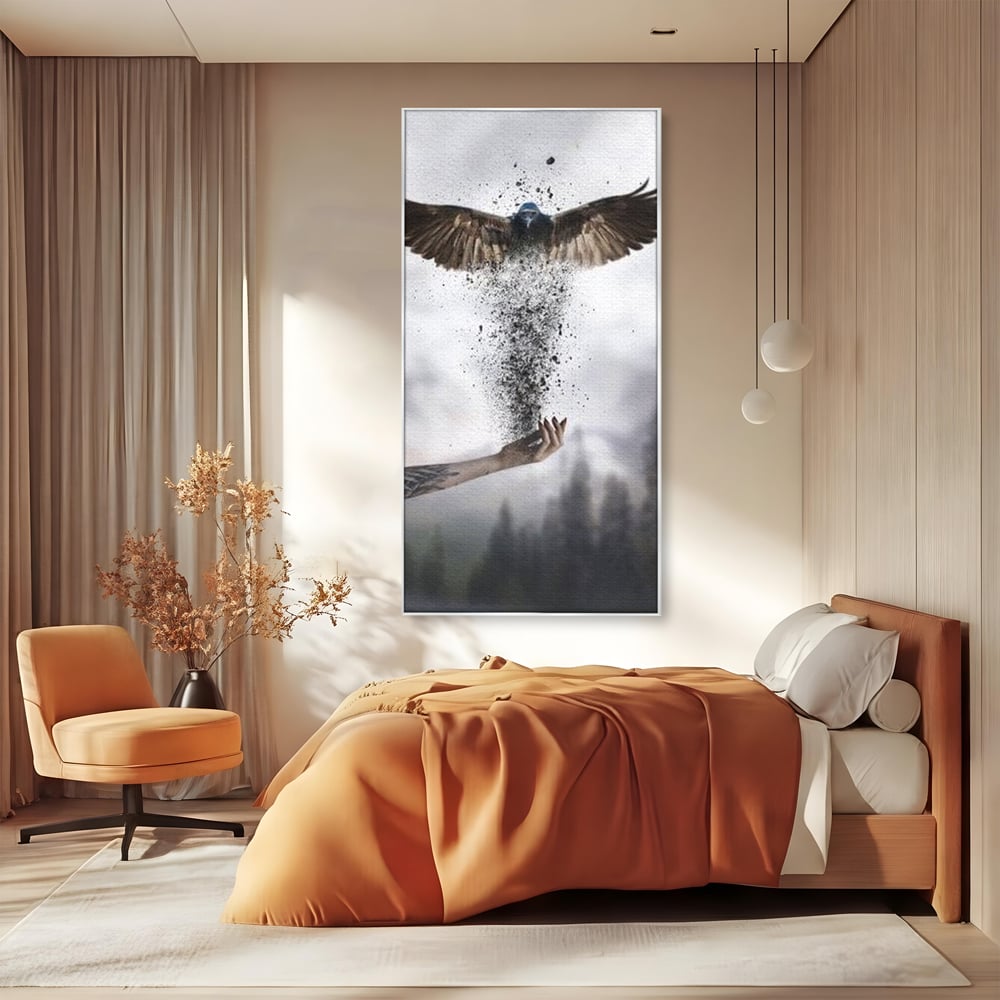 Tablou canvas cu tablou canvas cu pasare si mana din cenusa, in rama de aluminiu argintiu, pe perete intr-un dormitor